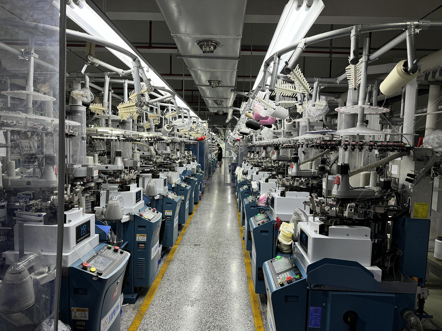 Rows of knitting machines in the GoodStartSocks workshop